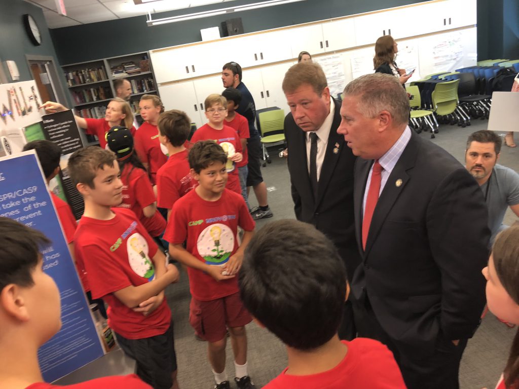 Photo of Assemblymembers John McDonald and Chris Tague speaking with students