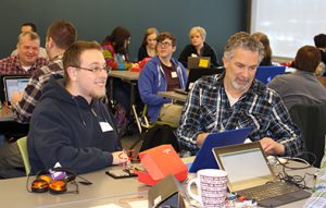 Photo of student working with a teacher at a computer science workshop