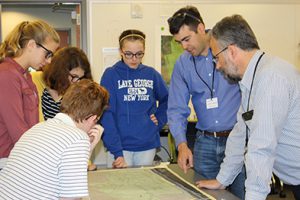 Photo of engineer reviewing a site plan with TVHS students.