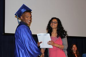 Photo of student receiving a diploma at graduation.