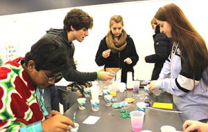 Photo of students working around a table