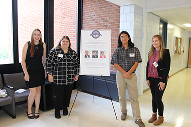 Photo of four students in front of a poster at Albany Medical Center