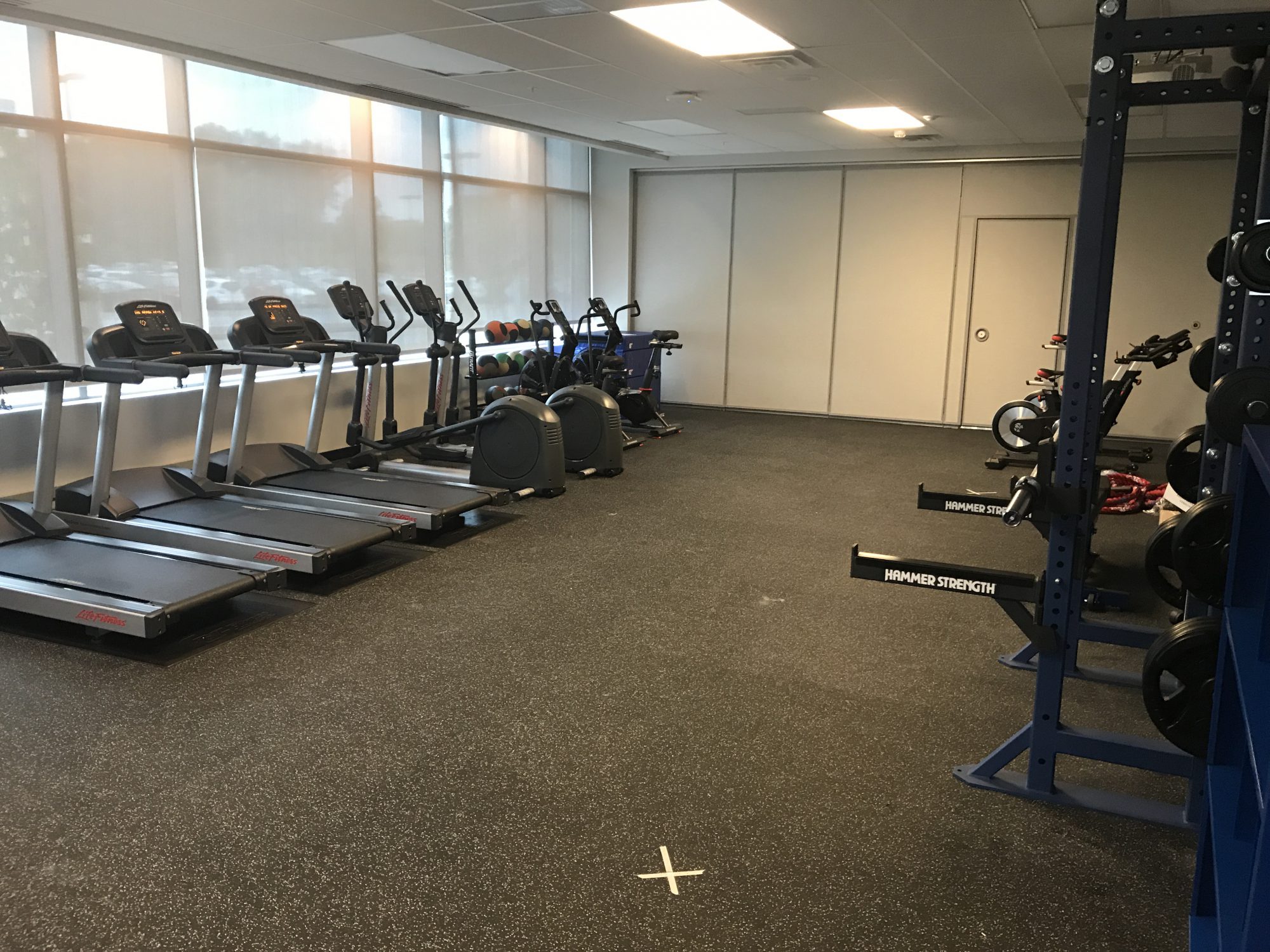 Photo of fitness center with treadmills, exercise bikes and free weights