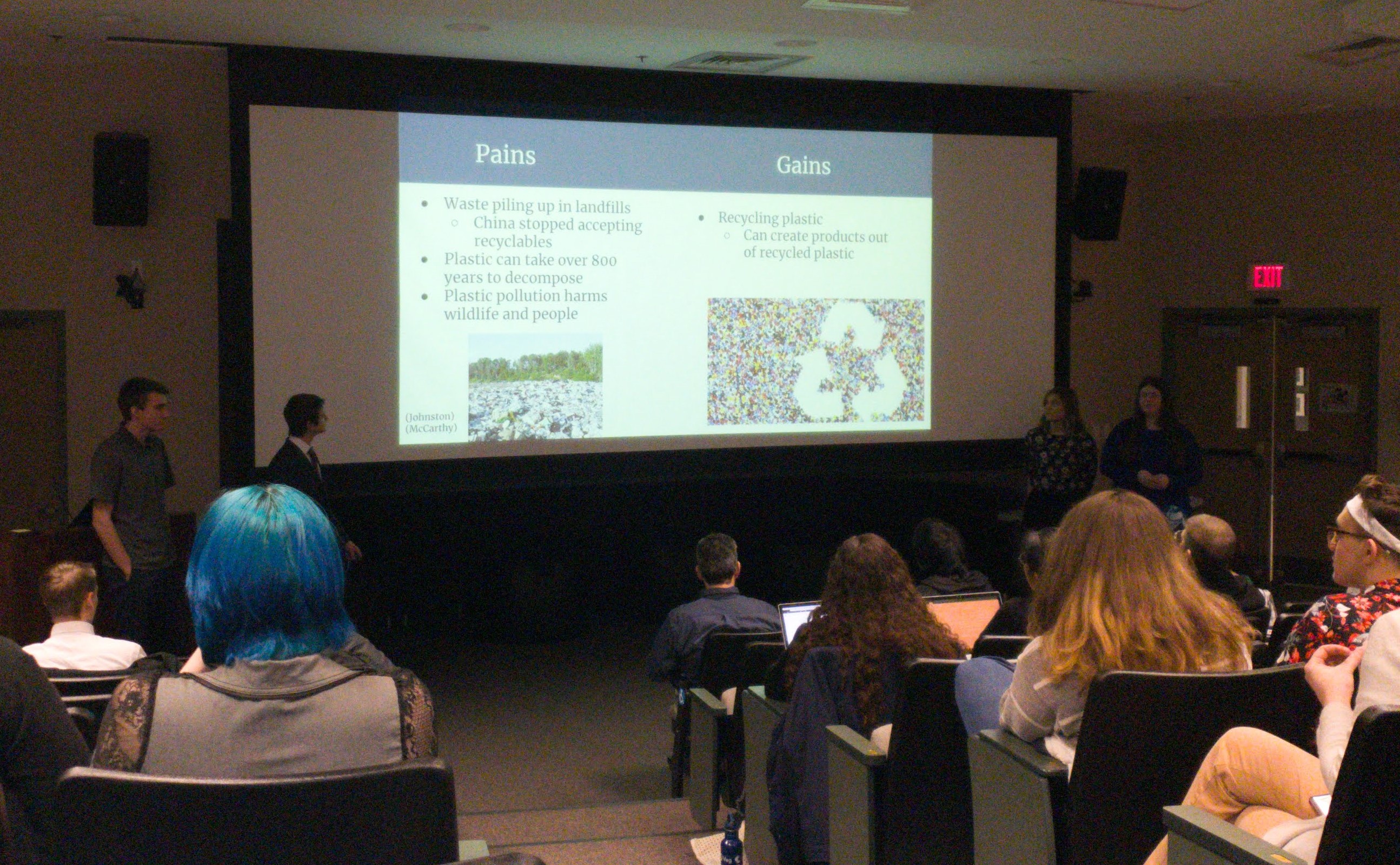 Photo of students presenting in small auditorium