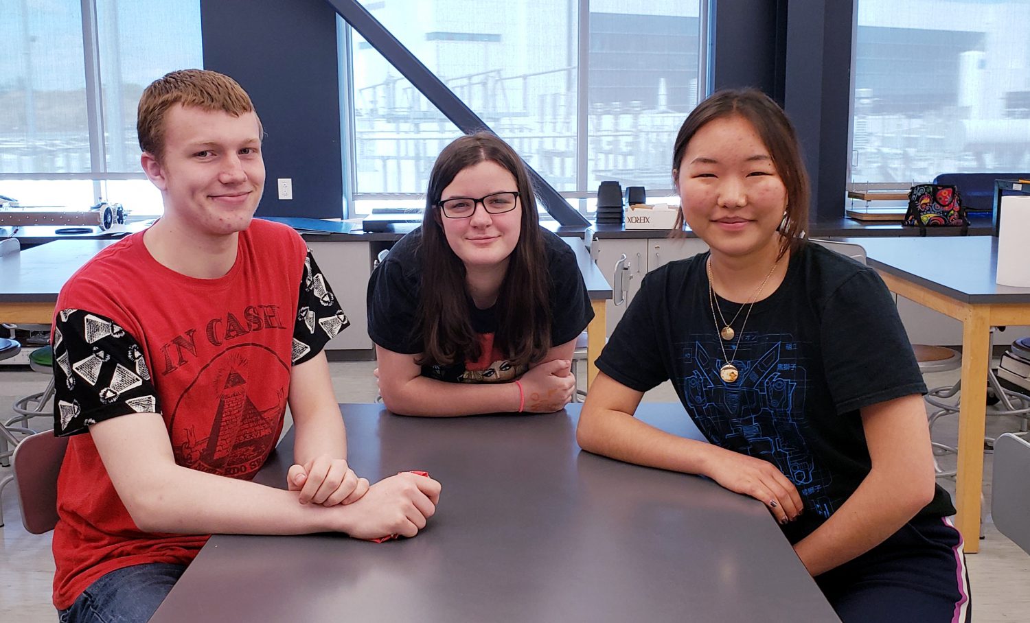 photo of three students around a table in a science classroom